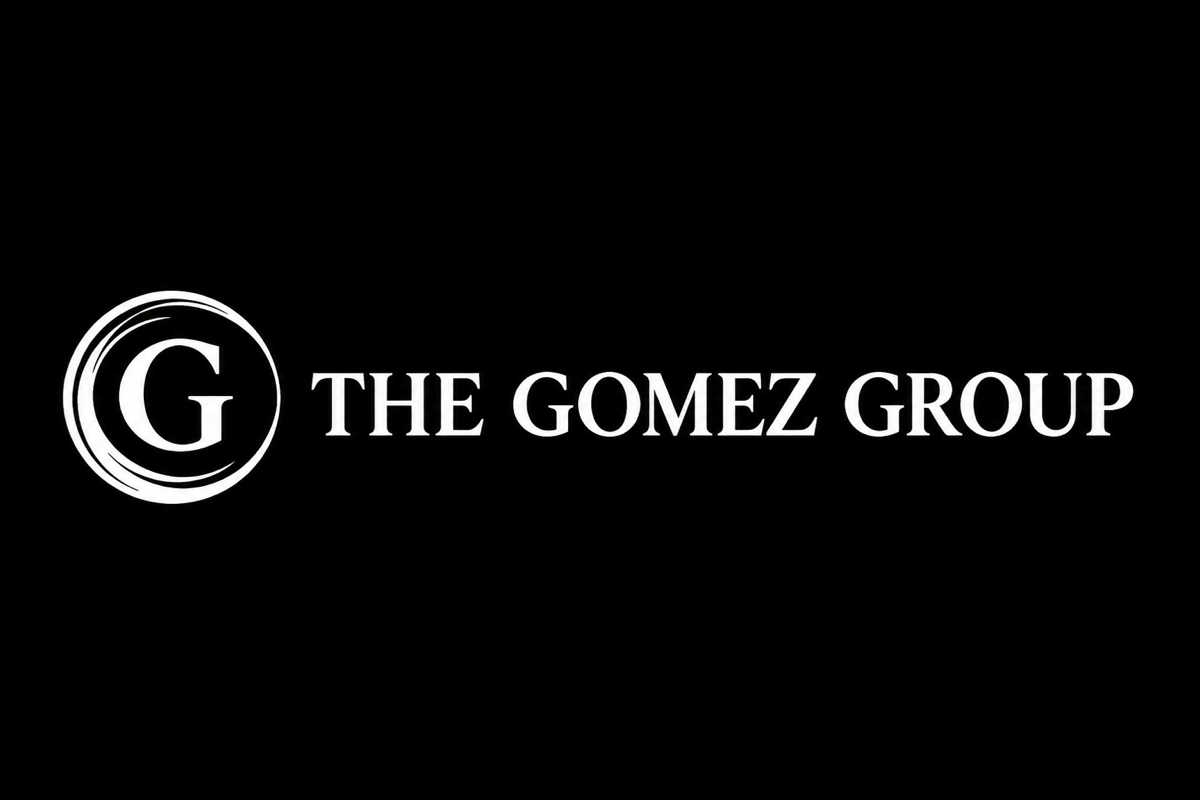 Horizontal lockup reversed: the white seal left of the white The Gomez Group wordmark on a dark ground