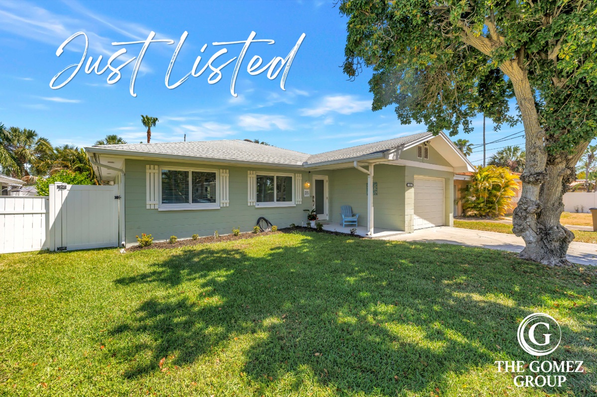 Coastal ranch home exterior with a Just Listed script overlay and The Gomez Group watermark